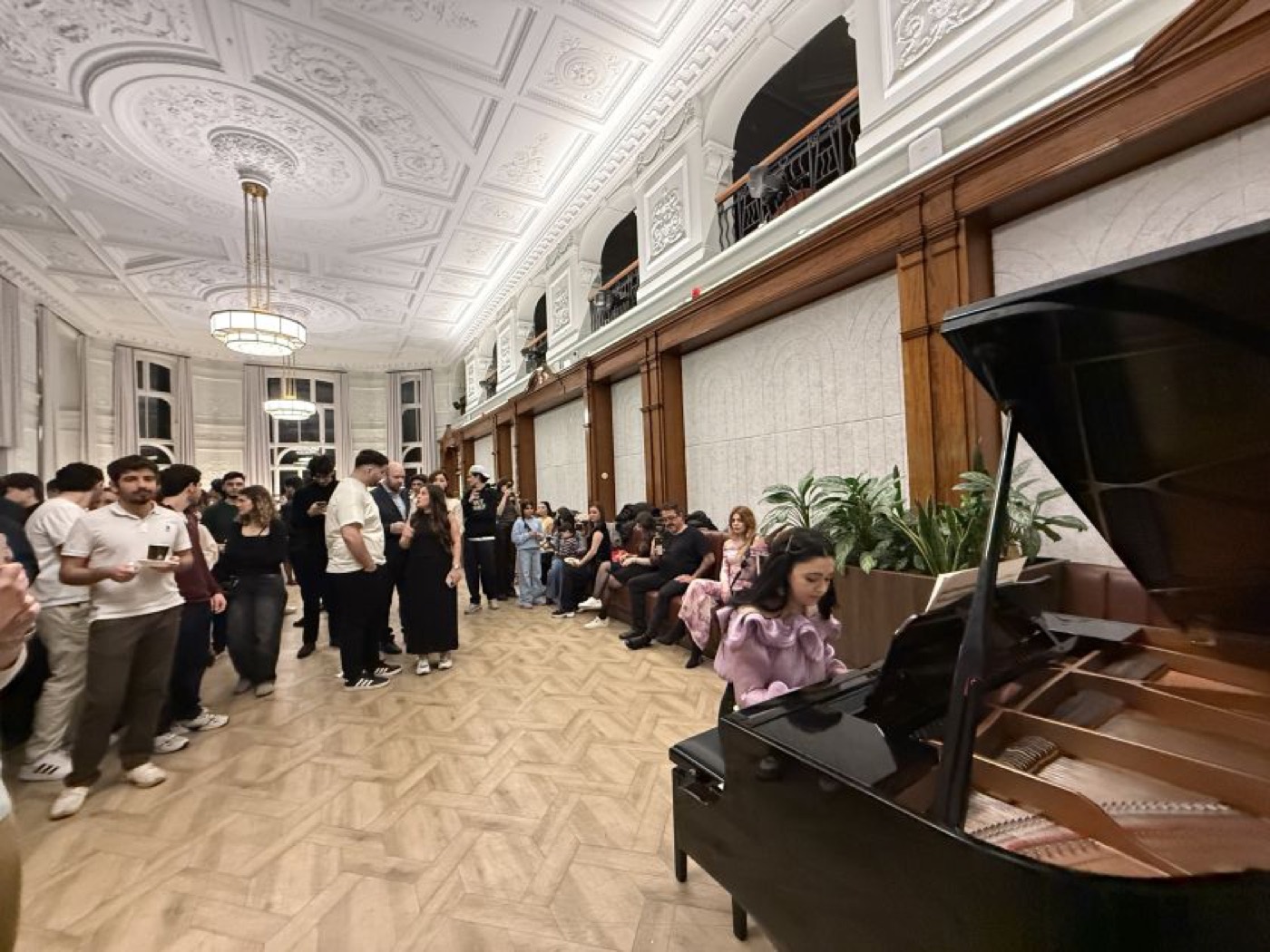 Guests enjoying şəkərbura and pakhlava at the Novruz event