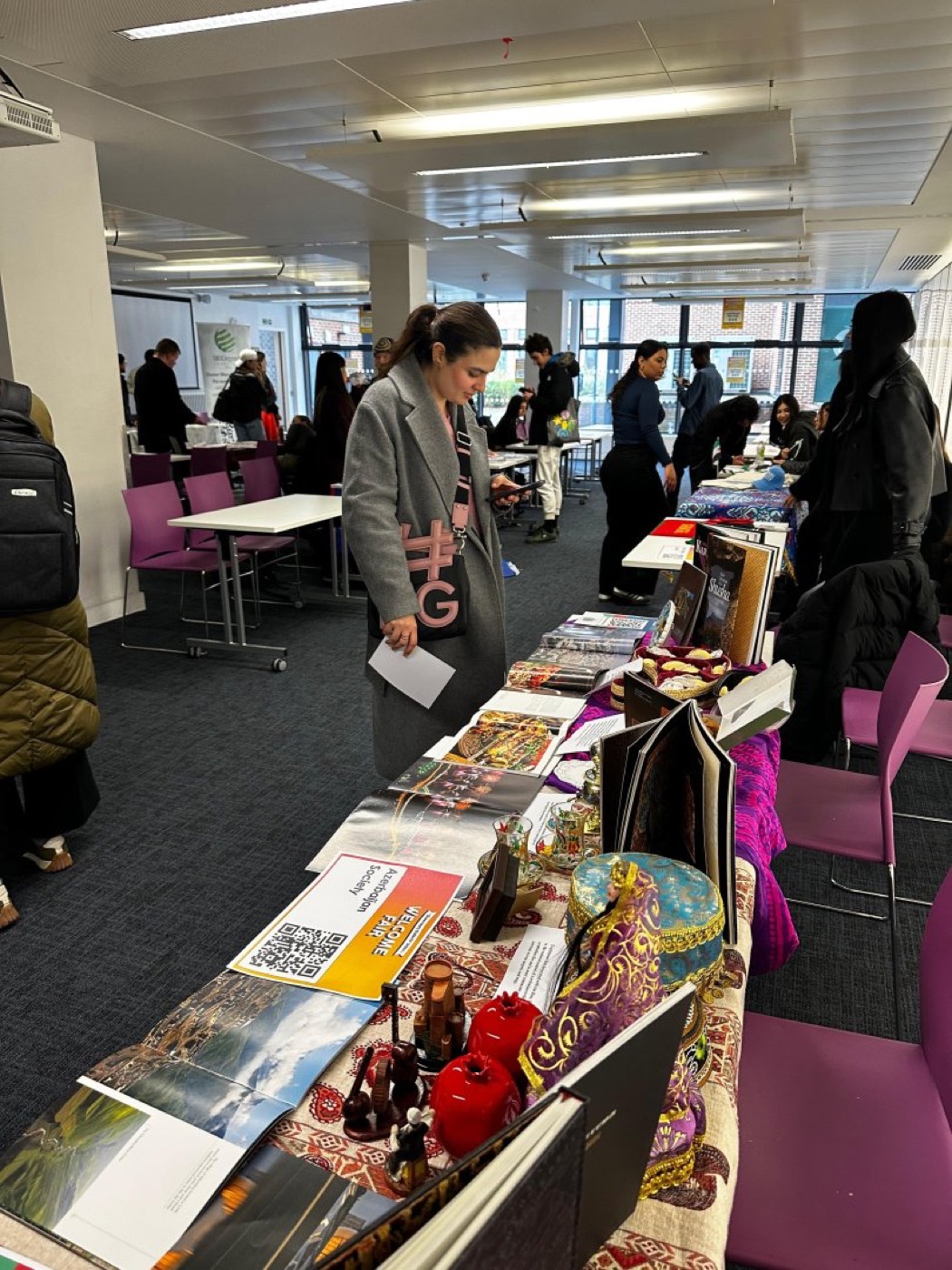 Students talking with committee members at the stand