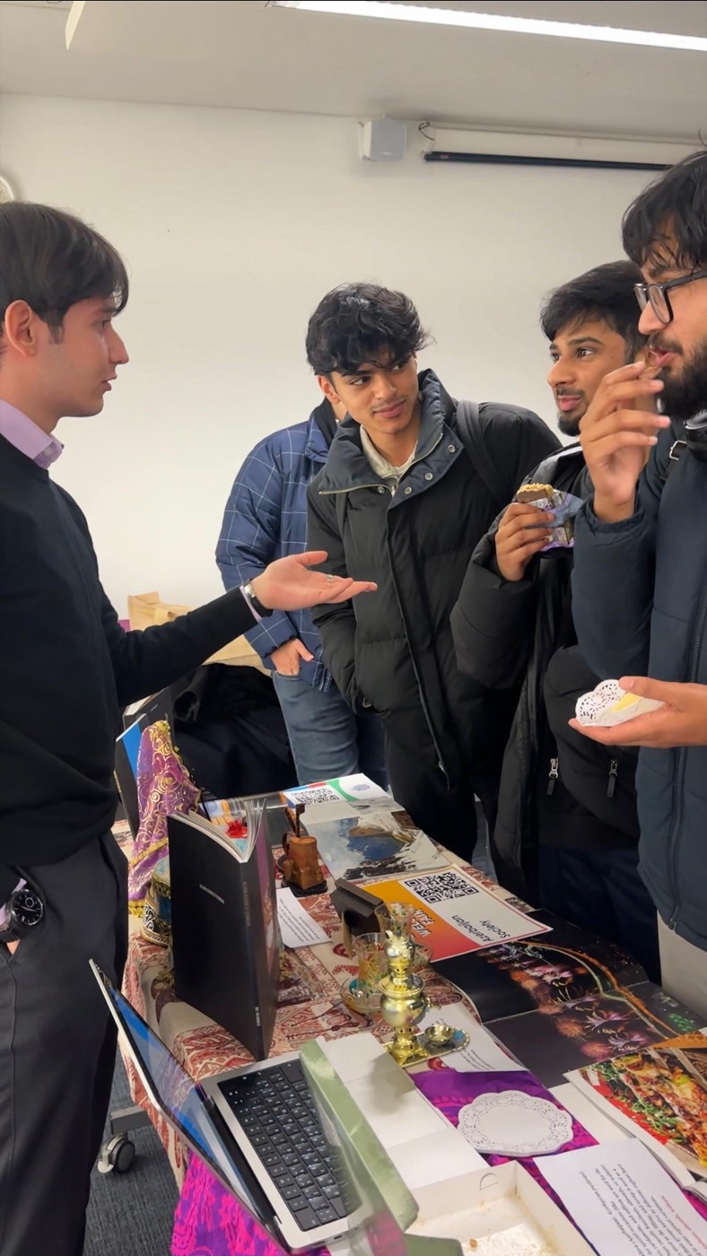 A visitor browsing books at the Azerbaijan Society stand