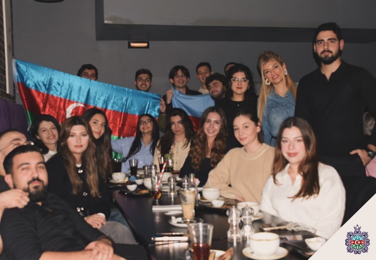 Society members at a dinner event with the Azerbaijan flag